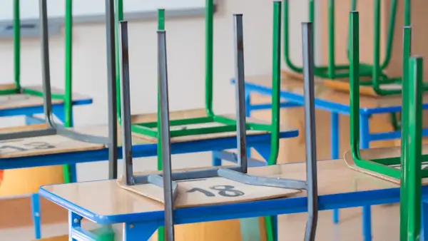Puste ławki i krzesła odwrócone do góry nogami w sali lekcyjnej. Czy to efekt cięć subwencji oświatowej?