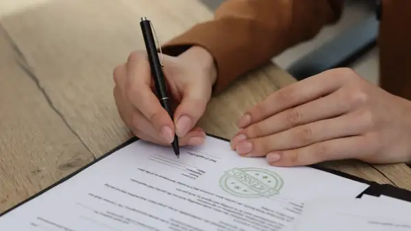 Osoba prawna podpisuje dokument, potwierdzając umowę.